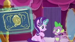 Size: 1280x720 | Tagged: safe, derpibooru import, screencap, spike, starlight glimmer, dragon, pony, unicorn, a-dressing memories, spoiler:a-dressing memories, spoiler:mlp friendship is forever, 9now, book, female, levitation, magic, male, mare, nine network, sitting, telekinesis