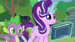 Size: 1280x720 | Tagged: safe, derpibooru import, screencap, spike, starlight glimmer, dragon, pony, unicorn, memnagerie, spoiler:memnagerie, spoiler:mlp friendship is forever, baby, baby dragon, book, cute, duo, female, glimmerbetes, glowing horn, hair flip, horn, levitation, magic, magic aura, male, mare, scrapbook, slit eyes, smiling, telekinesis, winged spike