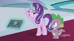 Size: 1280x720 | Tagged: safe, derpibooru import, screencap, spike, starlight glimmer, dragon, pony, unicorn, memories and more, spoiler:memories and more, spoiler:mlp friendship is forever, 9now, bedroom eyes, book, crossed arms, duo, levitation, looking at each other, magic, magic aura, scrapbook, telekinesis, winged spike