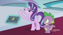 Size: 1280x720 | Tagged: safe, derpibooru import, screencap, spike, starlight glimmer, dragon, pony, unicorn, memories and more, spoiler:memories and more, spoiler:mlp friendship is forever, 9now, bedroom eyes, book, crossed arms, duo, levitation, looking at each other, magic, magic aura, scrapbook, telekinesis, winged spike