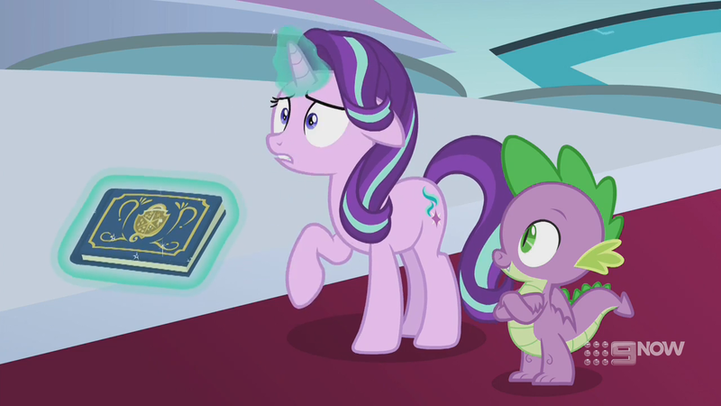 Size: 1280x720 | Tagged: safe, derpibooru import, screencap, spike, starlight glimmer, dragon, pony, unicorn, memories and more, spoiler:memories and more, spoiler:mlp friendship is forever, 9now, book, crossed arms, duo, levitation, magic, magic aura, scrapbook, shrunken pupils, telekinesis, winged spike, worried