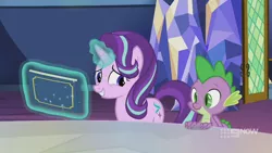 Size: 1280x720 | Tagged: safe, derpibooru import, screencap, spike, starlight glimmer, dragon, pony, unicorn, memories and more, spoiler:memories and more, spoiler:mlp friendship is forever, 9now, book, duo, levitation, magic, magic aura, scrapbook, smiling, telekinesis, winged spike, worried, worried smile