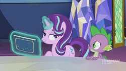 Size: 1280x720 | Tagged: safe, derpibooru import, screencap, spike, starlight glimmer, dragon, pony, unicorn, memories and more, spoiler:memories and more, spoiler:mlp friendship is forever, 9now, bedroom eyes, book, duo, levitation, magic, magic aura, mid-blink screencap, scrapbook, smiling, smug, telekinesis, winged spike