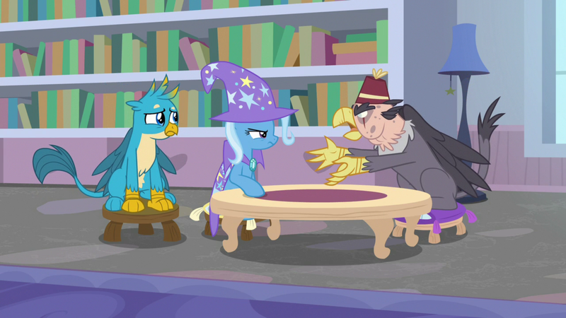 Size: 1920x1080 | Tagged: safe, derpibooru import, screencap, gallus, grampa gruff, trixie, gryphon, pony, unicorn, a horse shoe-in, blind eye, book, bookshelf, cape, clothes, eye scar, female, fez, hat, lamp, mare, pillow, scar, sitting, stool, table, trixie's cape, trixie's hat, window