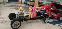 Size: 3264x1546 | Tagged: apple bloom, applejack, blind bag, chassis, chevrolet impala, derpibooru import, engine, everfree customs, ford crown victoria police interceptor, garage, pontiac gto, safe, toy, volkswagen beetle