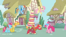 Size: 2000x1125 | Tagged: safe, derpibooru import, screencap, big macintosh, carrot cake, cup cake, fluttershy, pinkie pie, rainbow dash, earth pony, pegasus, pony, mmmystery on the friendship express, balancing, cake, female, flying, food, hard hat, male, mare, marzipan mascarpone meringue madness, ponyville, rope, stallion