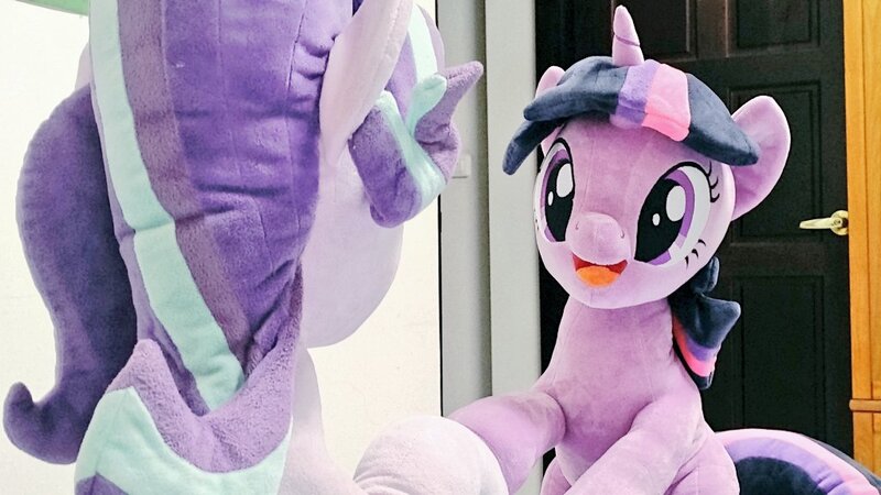 Size: 1024x576 | Tagged: safe, artist:nekokevin, derpibooru import, starlight glimmer, twilight sparkle, pony, unicorn, series:nekokevin's glimmy, duo, female, irl, looking at each other, mare, open mouth, photo, plushie, raised hoof, rear view, sitting, smiling, underhoof, unicorn twilight