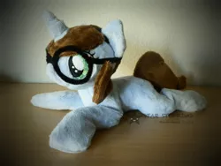 Size: 1024x768 | Tagged: safe, artist:starmassacre, derpibooru import, oc, oc:quiz, unofficial characters only, pony, unicorn, beanie (plushie), female, fluffy, glasses, horn, irl, mare, photo, plushie, prone, smiling, solo