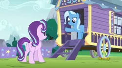 Size: 1008x565 | Tagged: safe, derpibooru import, screencap, starlight glimmer, trixie, pony, unicorn, no second prances, caravan, discovery family logo, female, mare, trixie's wagon, wagon