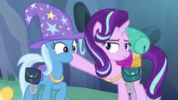 Size: 1280x720 | Tagged: safe, derpibooru import, screencap, starlight glimmer, trixie, pony, to where and back again, bag, clothes, hat, hoof in mouth, jewelry, necklace, saddle bag, trixie's hat