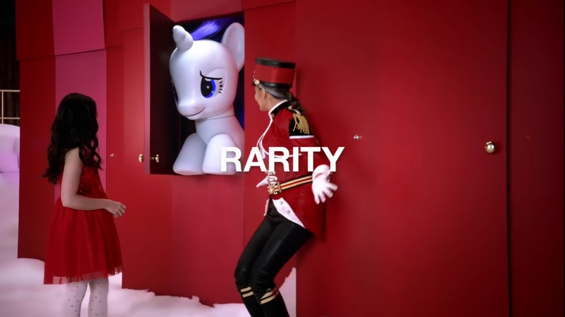 Size: 1282x719 | Tagged: safe, derpibooru import, screencap, rarity, human, pony, brushable, chrissy teigen, commercial, irl, isabella russo, live action, photo, pony reference, spoiler, target (store), text, the toycracker, toy