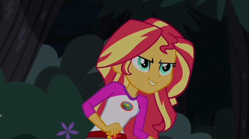 Size: 1100x618 | Tagged: safe, derpibooru import, screencap, sunset shimmer, equestria girls, legend of everfree, >:d, camp everfree outfits, clothes, evil grin, female, flower, grin, happy, shorts, smiling, smirk, solo