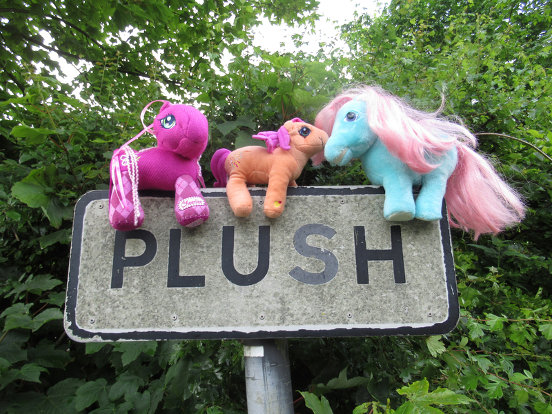 Size: 1800x1350 | Tagged: safe, artist:travelling-my-little-pony, derpibooru import, bowtie (g1), cheerilee (g3), sparkleworks, pony, g1, g3, irl, merchandise, photo, plushie, road sign, sign, straddling, toy