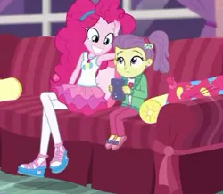 Size: 407x355 | Tagged: safe, derpibooru import, screencap, lily pad (equestria girls), pinkie pie, equestria girls, equestria girls series, pinkie sitting, clothes, couch, cropped, female, hairband, jacket, magical geodes, out of context, pants, pantyhose, shoes, side ponytail, skirt, smiling, young