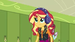 Size: 1280x720 | Tagged: safe, derpibooru import, screencap, sunset shimmer, velvet sky, equestria girls, equestria girls series, overpowered (equestria girls), background human, canterlot high, clothes, female, geode of empathy, headphones, lockers, magical geodes, solo