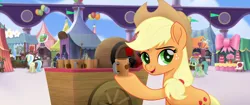 Size: 1920x804 | Tagged: safe, derpibooru import, screencap, applejack, earth pony, pony, my little pony: the movie, applejack's hat, balloon, cake, cart, cider, cotton candy, cowboy hat, cup, female, flag, food, hat, mug, smiling, solo, tankard