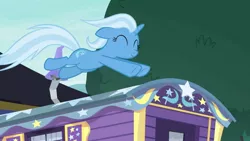 Size: 1280x720 | Tagged: safe, derpibooru import, screencap, trixie, pony, unicorn, road to friendship, eyes closed, female, floppy ears, leaping, mare, smiling, solo, trixie's wagon, wagon