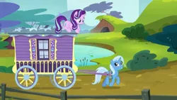 Size: 1280x720 | Tagged: safe, derpibooru import, screencap, starlight glimmer, trixie, pony, unicorn, road to friendship, duo, duo female, female, looking at each other, mare, prone, trixie's wagon, wagon