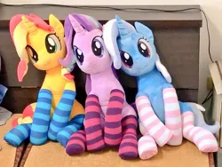 Size: 1024x768 | Tagged: safe, artist:nekokevin, derpibooru import, starlight glimmer, sunset shimmer, trixie, pony, unicorn, series:nekokevin's glimmy, clothes, counterparts, cute, female, irl, looking at you, magical trio, mare, photo, plushie, sitting, socks, striped socks, trio, twilight's counterparts