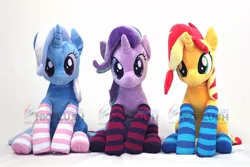 Size: 1200x800 | Tagged: safe, artist:nekokevin, derpibooru import, starlight glimmer, sunset shimmer, trixie, pony, unicorn, series:nekokevin's glimmy, clothes, counterparts, cute, female, irl, looking at you, magical trio, mare, photo, plushie, sitting, smiling, socks, striped socks, trio, twilight's counterparts, watermark