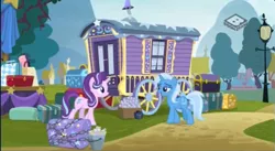 Size: 574x315 | Tagged: safe, derpibooru import, screencap, starlight glimmer, trixie, pony, unicorn, road to friendship, boomerang (tv channel), caravan, chains, chest, duo, female, lamppost, luggage, mare, outdoors, stage, trixie's wagon