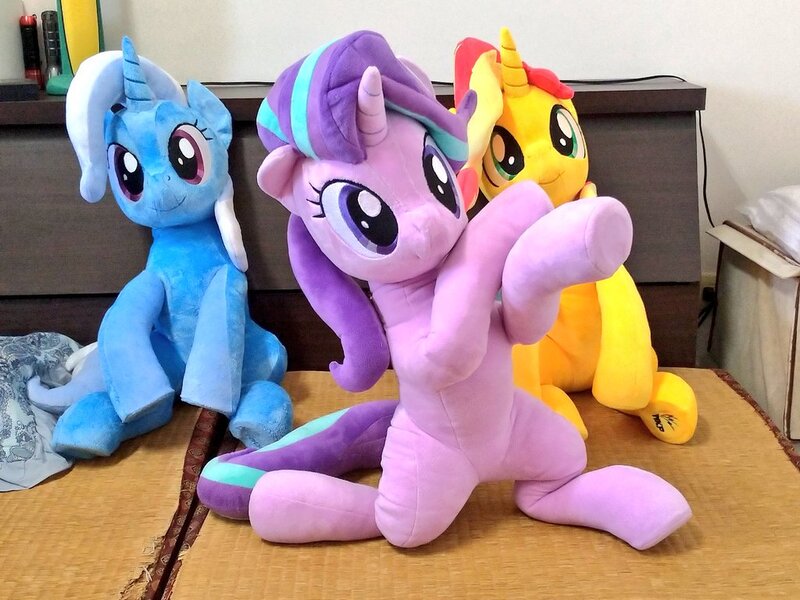 Size: 1024x768 | Tagged: safe, artist:nekokevin, derpibooru import, starlight glimmer, sunset shimmer, trixie, pony, unicorn, series:nekokevin's glimmy, female, irl, looking at you, magical trio, mare, photo, plushie, pose, raised hoof, sitting, smiling, underhoof