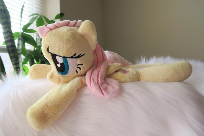 Size: 5472x3648 | Tagged: safe, artist:kazzysart, derpibooru import, fluttershy, pegasus, pony, beanie (plushie), female, folded wings, irl, mare, photo, plushie, prone, solo, wings