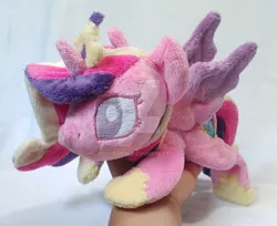 Size: 1024x834 | Tagged: safe, artist:appledew, derpibooru import, princess cadance, alicorn, pony, beanie (plushie), female, hand, horn, irl, jewelry, mare, photo, plushie, prone, regalia, solo, wings