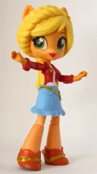 Size: 1101x1970 | Tagged: safe, artist:whatthehell!?, derpibooru import, applejack, equestria girls, clothes, doll, equestria girls minis, eqventures of the minis, irl, merchandise, photo, ponied up, shoes, skirt, theme park, toy