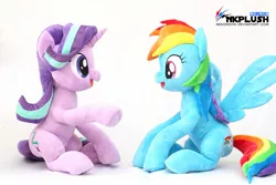 Size: 1200x800 | Tagged: safe, artist:nekokevin, derpibooru import, rainbow dash, starlight glimmer, pegasus, pony, unicorn, series:nekokevin's glimmy, cute, dashabetes, duo, female, glimmerbetes, irl, looking at each other, mare, open mouth, photo, plushie, raised hoof, simple background, sitting, smiling, spread wings, underhoof, watermark, white background, wings