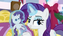 Size: 1280x720 | Tagged: safe, derpibooru import, screencap, rarity, pony, unicorn, hearth's warming shorts, mystery voice, bedroom eyes, button eyes, female, hearth's warming doll, lidded eyes, magic, magic aura, mare, rarity plushie, self plushidox, solo, telekinesis