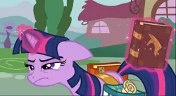 Size: 1422x774 | Tagged: safe, derpibooru import, screencap, twilight sparkle, pony, unicorn, hearts and hooves day (episode), bag, book, female, floppy ears, glowing horn, horn, levitation, magic, mare, narrowed eyes, saddle bag, solo, telekinesis, twilight is not amused, unamused, unicorn twilight