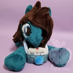 Size: 1188x1188 | Tagged: safe, artist:appledew, derpibooru import, ponified, earth pony, pony, beanie (plushie), camera, clothes, commission, irl, male, photo, plushie, prone, shirt, smiling, solo, stallion, t-shirt, tom sykes, watermark