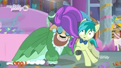Size: 1366x768 | Tagged: safe, derpibooru import, screencap, sandbar, yona, earth pony, pony, yak, she's all yak, alternate hairstyle, blushing, bowl, bowtie, bucket, clothes, cloven hooves, cup, dress, duo, ear piercing, earring, eyeshadow, female, food, jewelry, lemon, makeup, male, pearl earrings, piercing, punch (drink), punch bowl, teenager, wig