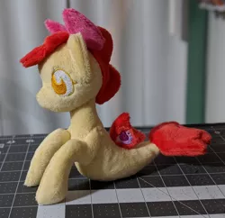 Size: 2148x2083 | Tagged: apple bloom, artist:plushbyanto, beanie (plushie), bow, chibi, derpibooru import, female, filly, fins, irl, lying down, no mouth, no nostrils, no pupils, photo, plushie, profile, race swap, safe, seaponified, seapony apple bloom, seapony (g4), solo, species swap, tail fin, toy