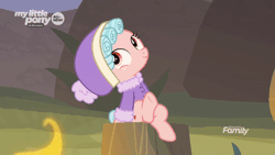 Size: 600x338 | Tagged: safe, derpibooru import, screencap, cozy glow, pegasus, pony, frenemies (episode), animated, clothes, cozybetes, cute, discovery family logo, female, filly, fire, foal, freckles, gif, hat, hnnng, leg wiggle, looking up, perfect loop, sitting, solo, talking, tree stump, winter outfit
