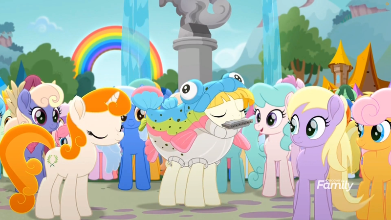 Size: 1699x956 | Tagged: safe, derpibooru import, screencap, kersplash, rainbow trout (character), unnamed character, unnamed pony, earth pony, fish, pony, unicorn, rainbow roadtrip, animal costume, background pony, clothes, costume, discovery family logo, eyes closed, female, fish costume, fountain, harmonica, hope hollow, male, mare, musical instrument, outdoors, playing instrument, rainbow, stallion, statue, tree
