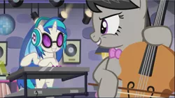 Size: 1669x941 | Tagged: safe, derpibooru import, screencap, octavia melody, vinyl scratch, earth pony, pony, unicorn, slice of life (episode), background pony, bipedal, bow, cello, cropped, disco ball, duo, evil grin, female, grin, headphones, looking at each other, mare, musical instrument, playing instrument, smiling, smirk, synthesizer, turntable