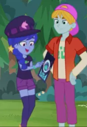 Size: 447x650 | Tagged: safe, derpibooru import, screencap, fry lilac, space camp (character), equestria girls, equestria girls series, the road less scheduled, the road less scheduled: microchips, spoiler:choose your own ending (season 2), spoiler:eqg series (season 2), backwards ballcap, baseball cap, cap, clothes, cropped, female, hat, male, not luna, shorts, smiling