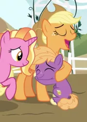 Size: 440x615 | Tagged: safe, derpibooru import, screencap, applejack, little mac, luster dawn, earth pony, pony, unicorn, the last problem, aunt and nephew, colt, cropped, cutie mark, eyes closed, female, hug, male, mare, older, older applejack, smiling