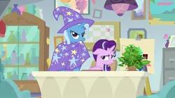 Size: 1920x1080 | Tagged: safe, derpibooru import, screencap, phyllis, starlight glimmer, trixie, pony, unicorn, a horse shoe-in, cape, clothes, female, hat, mare, trixie's cape, trixie's hat, unamused