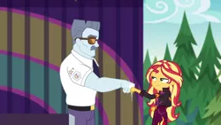 Size: 1920x1080 | Tagged: safe, derpibooru import, screencap, max steele, sunset shimmer, equestria girls, equestria girls series, sunset's backstage pass!, spoiler:eqg series (season 2), female, fist bump, male, outdoors, pine tree, security guard, sunglasses, tree