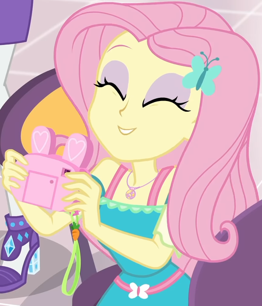 Size: 855x1000 | Tagged: safe, derpibooru import, screencap, fluttershy, rarity, equestria girls, equestria girls series, holidays unwrapped, spoiler:eqg series (season 2), bunny ears, camera, canterlot mall, chair, clothes, cropped, cute, dashing through the mall, dress, eyes closed, female, flower, geode of fauna, gift giving, hairclip, happy, jewelry, magical geodes, mall, necklace, present, shyabetes, sitting, smiling, table, waistband