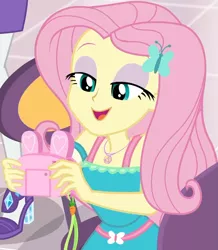 Size: 857x985 | Tagged: safe, derpibooru import, screencap, fluttershy, rarity, equestria girls, equestria girls series, holidays unwrapped, spoiler:eqg series (season 2), bunny ears, camera, canterlot mall, chair, clothes, cropped, cute, dashing through the mall, dress, female, flower, geode of fauna, gift giving, hairclip, happy, jewelry, lidded eyes, looking down, magical geodes, mall, necklace, present, shyabetes, sitting, smiling, table, waistband