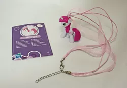 Size: 570x395 | Tagged: artist:butterscotch25, collector card, derpibooru import, irl, jewelry, lovestruck, necklace, photo, safe, toy