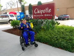 Size: 1024x768 | Tagged: chipotle, clothes, cosplay, costume, derpibooru import, human, irl, irl human, kid, photo, safe, sign, soarin', solo, soren, uniform, wheelchair, wonderbolts uniform