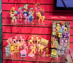Size: 500x434 | Tagged: safe, derpibooru import, official, applejack, fluttershy, pinkie pie, princess cadance, princess luna, twilight sparkle, twilight sparkle (alicorn), zecora, alicorn, pony, zebra, female, irl, mare, my little pony pop!, photo, sprue pony, toy, toy fair 2014