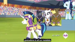 Size: 1280x719 | Tagged: safe, derpibooru import, edit, edited screencap, screencap, fleetfoot, gaston (griffon), giselle, irma, natalya, shining armor, soarin', gryphon, equestria games (episode), bronze medal, caption, crowd, crystal empire, equestria games, gold medal, hub logo, medal, meme, stadium, youtube caption