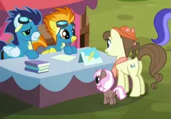 Size: 735x514 | Tagged: safe, derpibooru import, screencap, brown sugar, pegasus olsen, peggy holstein, sea swirl, seafoam, soarin', spitfire, earth pony, pegasus, unicorn, party pooped, 5-year-old, booth, clothes, female, filly, goggles, male, mare, stallion, uniform, wonderbolts uniform