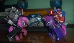 Size: 900x523 | Tagged: burger king toys, derpibooru import, fight, irl, megatron, optimus prime, photo, pinkie pie, riding, safe, toy, toy pony cavalry, transformers, twilight sparkle